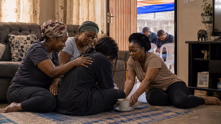 A widow does not mourn alone, the whole room, the whole neighborhood holds her up. (Image is artists impression).