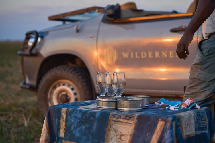 A standout spectacle of the plains: uninterrupted views of the sunsets, sundowners on the open plains and the guides that bring the bush to life. (Image by Chona Mweemba for Nkwazi Magazine).