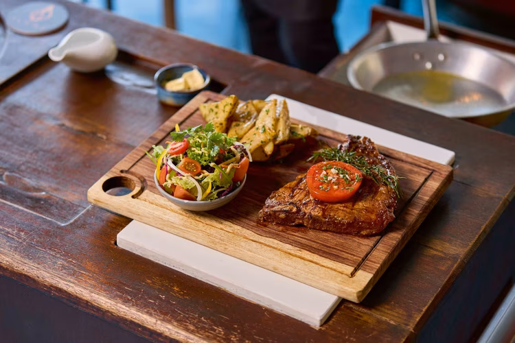 Flame knows what it's doing when it comes to steak. Whether you want it rare, medium, or well-done, they cook it perfectly. (Image by Justine Kunda for Nkwazi Magazine).