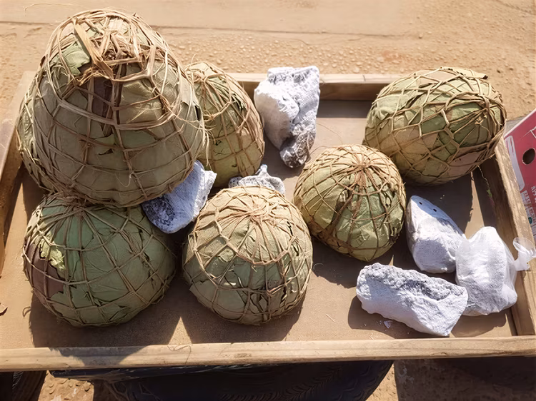 Water is poured through the ash-filled calabash, dissolving the salt and filtering it through small holes at the bottom.