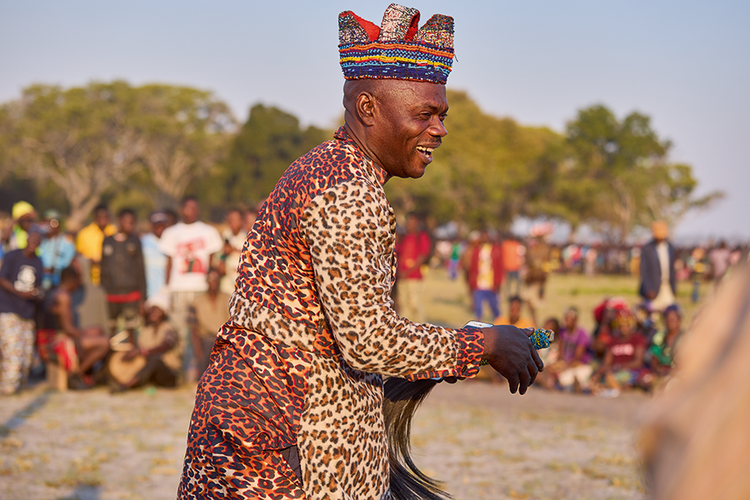 Leader of the Chota cha Chokwe Cultural Troupe reacts to the sounds of the friction drums being played. (Image by Nkwazi/Justine Kunda).